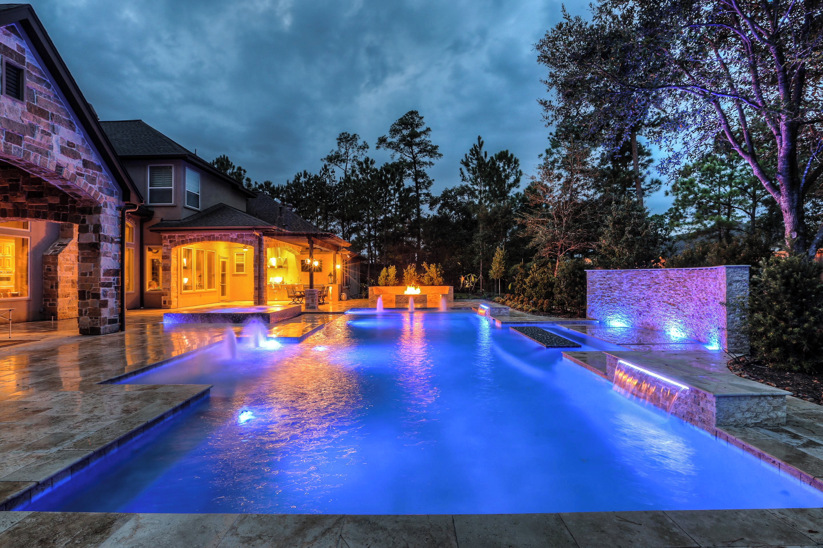 Modern residential swimming pool with blue pool lights